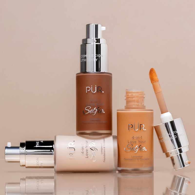 PUR Cosmetics foundation bottles and applicator on a beige background