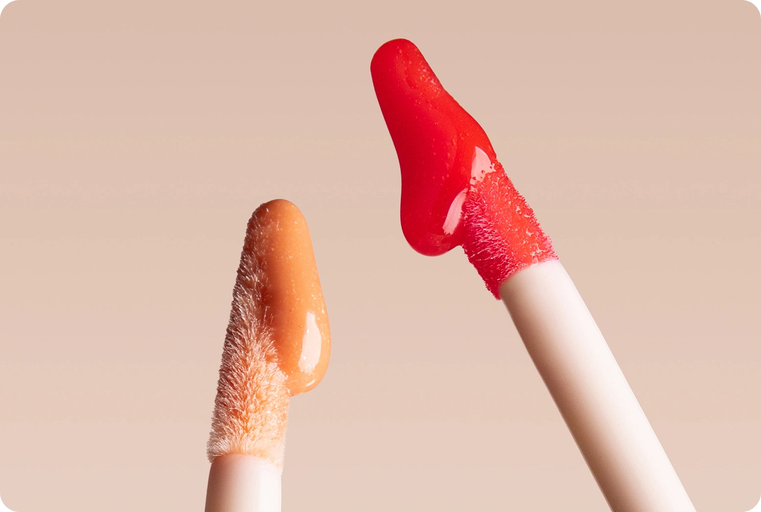 Memorial Day - 30% Off Sitewide: Glossy Lip Tint applicators dripping product against pink background