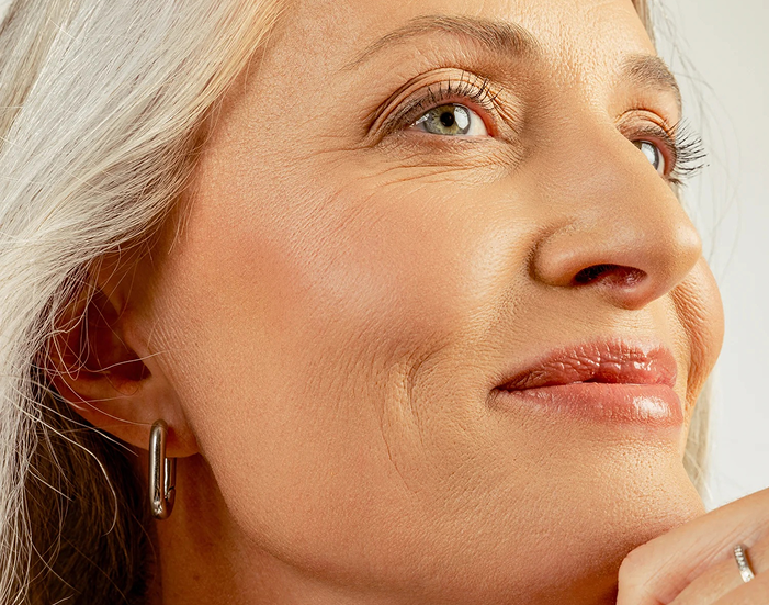 Close-up of a woman's face with a soft focus on her skin texture.