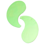 Two green hydrogel eye patches on a clean white background to show size and curved design.